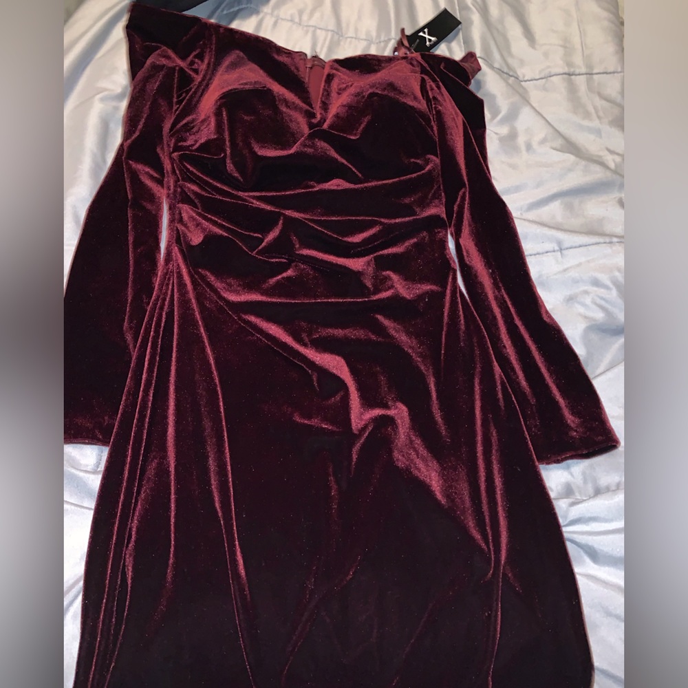 Burgundy velvet dress off shoulders and has a small slit in the back.